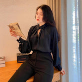 Tailored silk pants with high-rise waist and sleek straight-leg silhouette for elevated styling